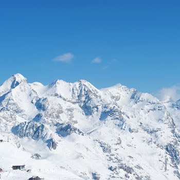Snow-covered mountain range and blue sky