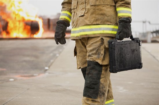 Fire fighter walking with Dell Rugged laptop