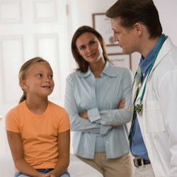 Doctor with young patient and mother