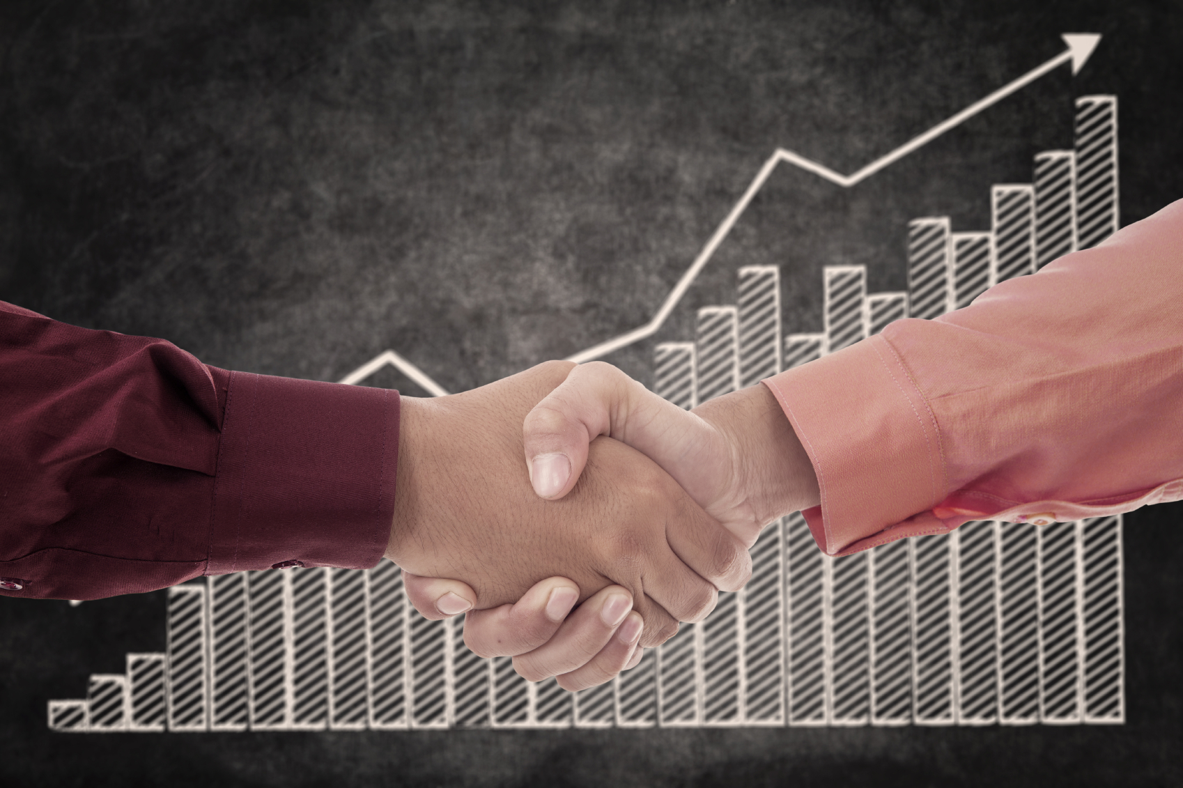 Handshake between two businessmen upon successful transactions