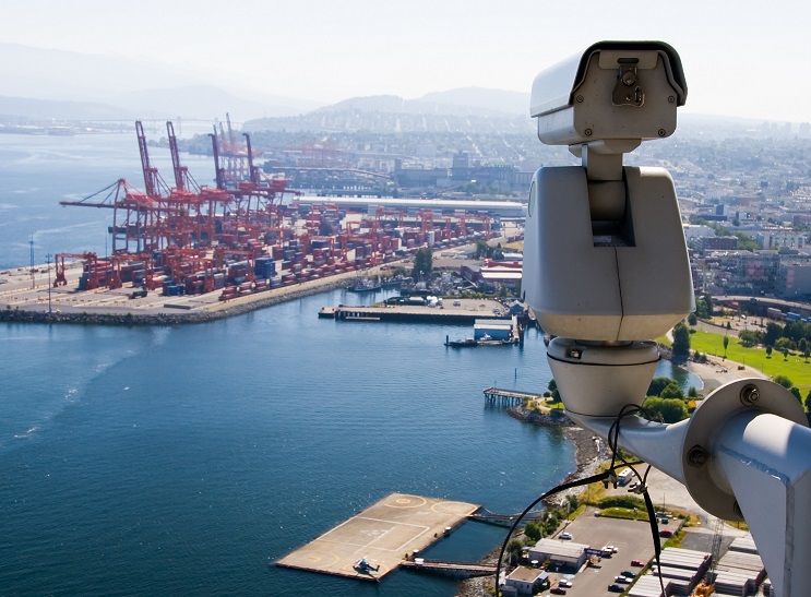 Surveillance Camera is watching operation in the port.