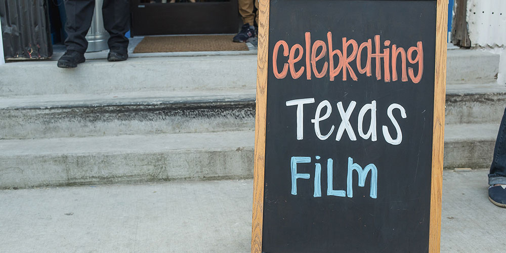 sign outside Dell event that says celebrate texas film