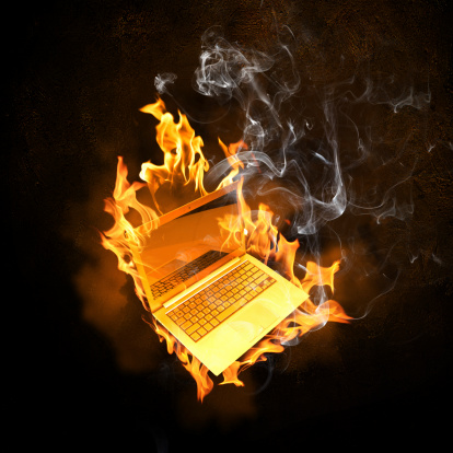 Laptop in fire flames