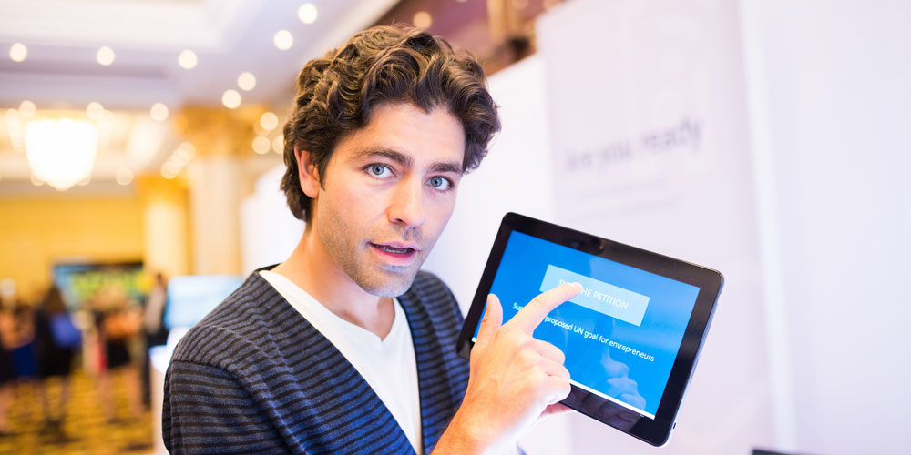 Actor and Dell Social Good Advocate Adrian Grenier holding a tablet