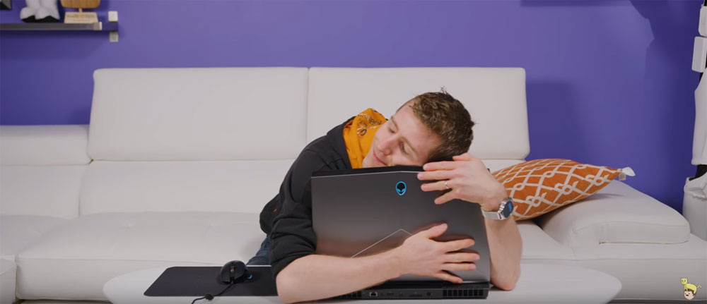 Linus Sebastian of Linus Tech Tips hugging an Alienware 15 laptop