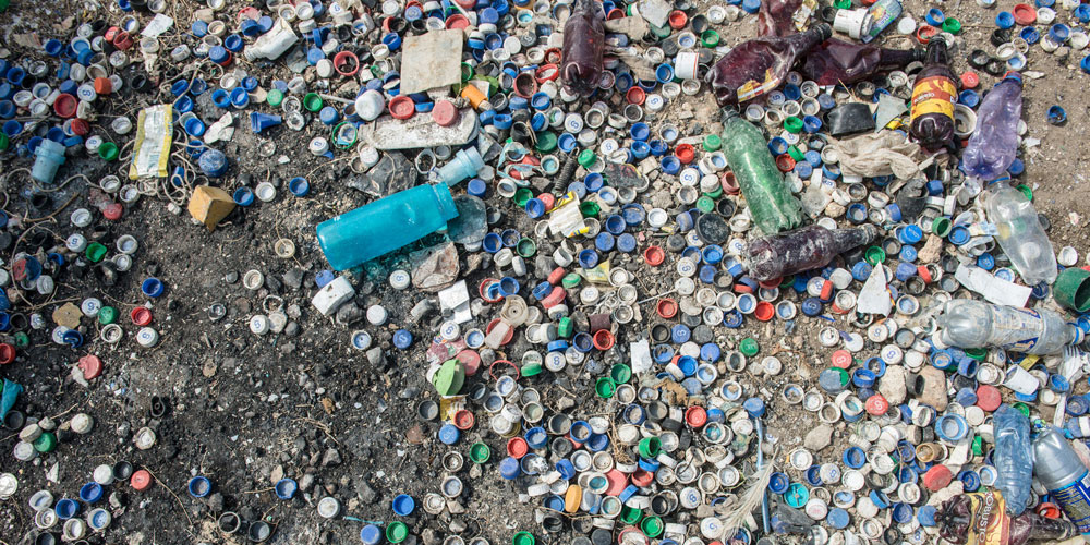 Plastic bottles and bottle caps washed ashore a beach