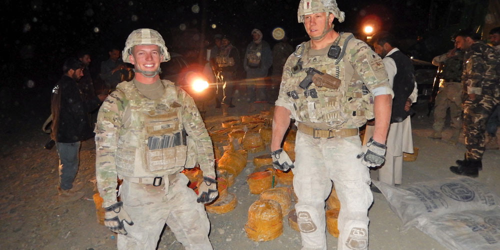 Two members of an Explosive Ordinance Disposal team with remains of vehicle-borne-improvised explosive devices