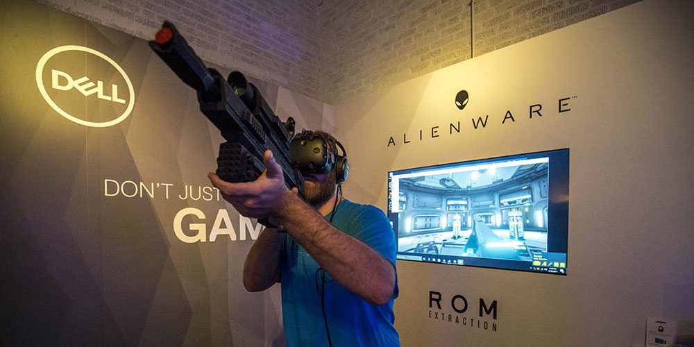 man with toy gun playing video game while wearing vr headset