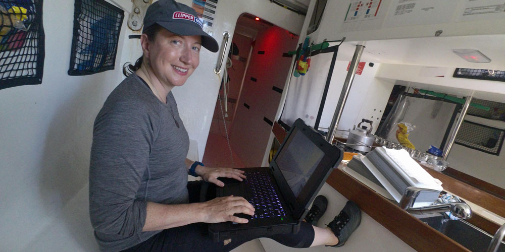 Samantha using her Dell Rugged laptop below deck of ship