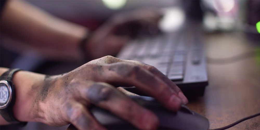 hands covered in grease and dirt on a Dell computer keyboard and mouse