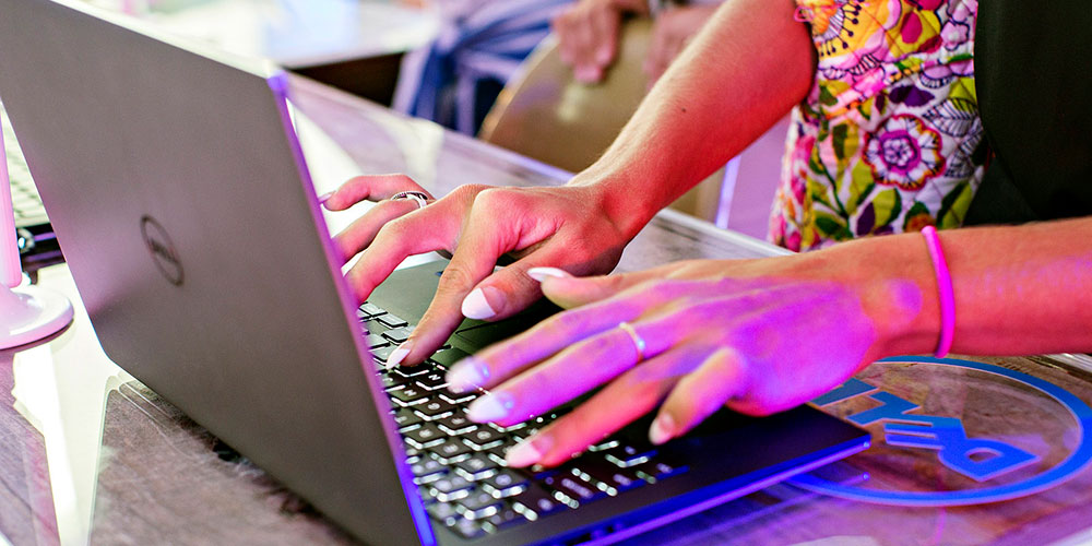 woman's hands typing on dell xps 13 laptop