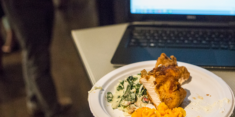 plate of food in front of a Dell laptop on a table