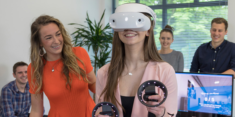 woman using a Dell mixed reality headset while others watch