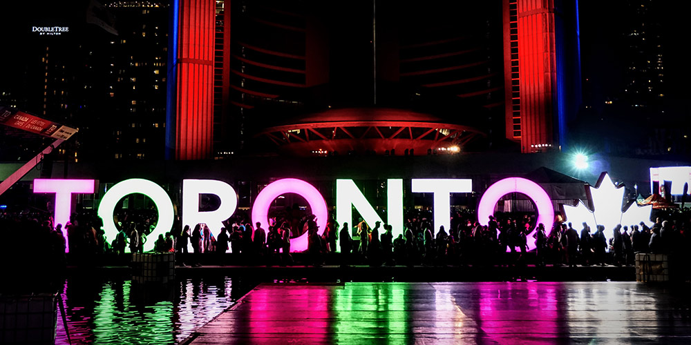 large illuminated letters spelling Toronto outside at night 