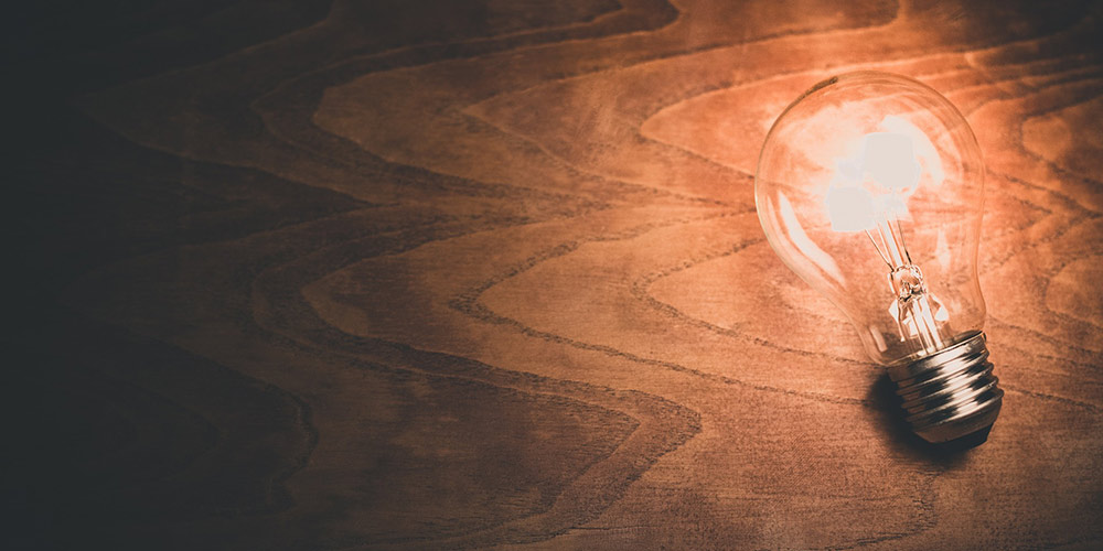 light bulb in front of a wood grain background