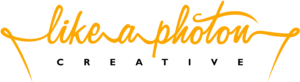 Company logo for Like a Photon Creative, in yellow cursive font.