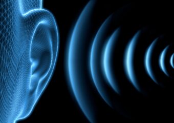 Image of sound waves approaching a person's ear.
