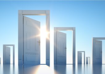 Multiple door frames with open doors scattered across a blue background with sun shining through the closest doorway.