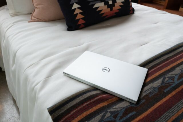 XPS 13 Plus resting on a bedspread. 