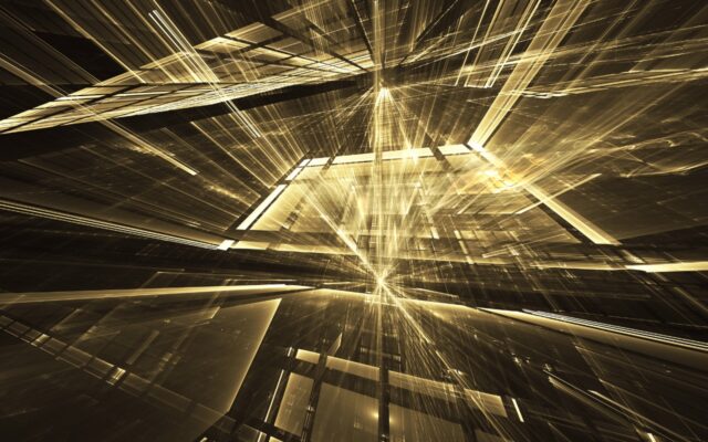 Abstract image of gold colored fractals and rays against a dark background.