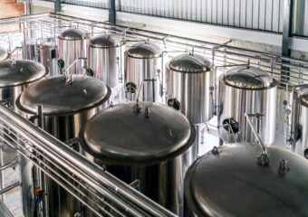 Metallic vats in operation at a brewery.
