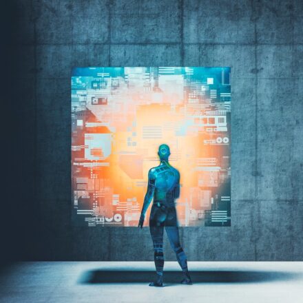 Cyborg or android looking at image on futuristic cube-shaped display.