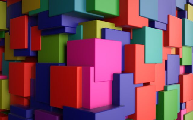 Colorful interlocking block pieces assembleld as part of a larger shape.