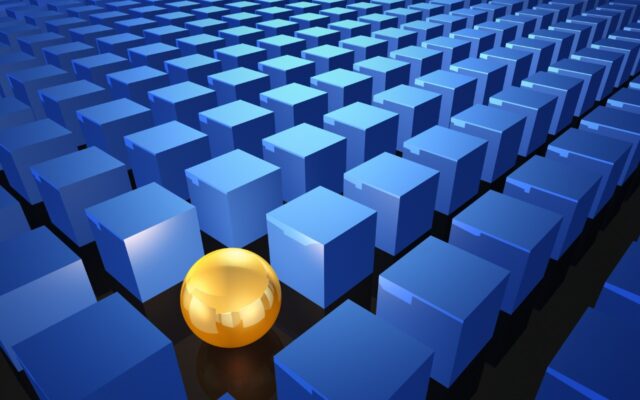 Gold sphere standing out amidst blue colored cubes in rows.