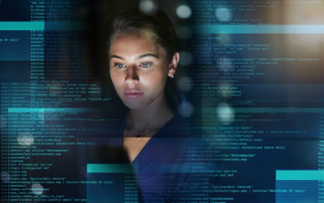 Young woman coding, with digital overlay of programming code superimposed around her.