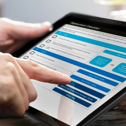 IT professional following a Dell PowerStore deployment checklist on a Latitude 7320 tablet.