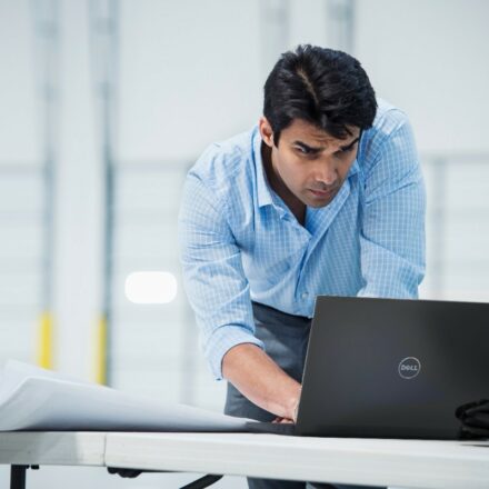 Male team member working remotely using Dell Latitude 14 7480 laptop.