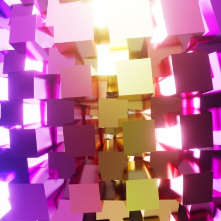 3D rendering of geometric shapes of pink, purple, blue and gold colors backlit.