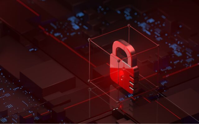 Red padlock in locked position on a motherboard, representative of cybersecurity against ransomware, malware and other threats.