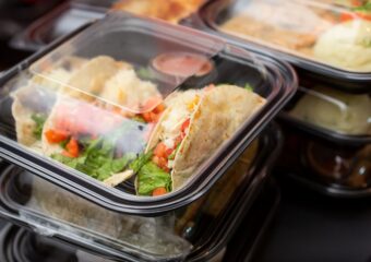 Restaurant delivery order in clear topy to-go containers.