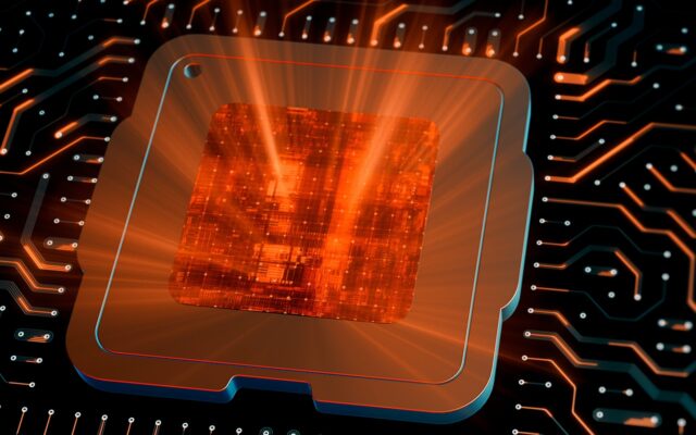 Digitally generated image of CPU chip on motherboard with its center emitting orange light outward.