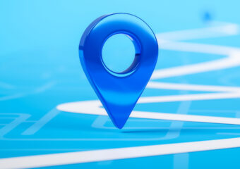 Location pin on a map along a winding route, in white against a light blue background. Other location pins are faintly seen in the far background.